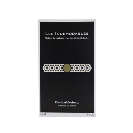 Close-up image showcasing the elegant design of the 'Hazelnut Patchouli' bottle by Les Indemodables.