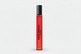 Red perfume bottle with black cap on a white background