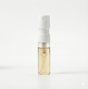 Small spray bottle with a white cap and clear body on a white background